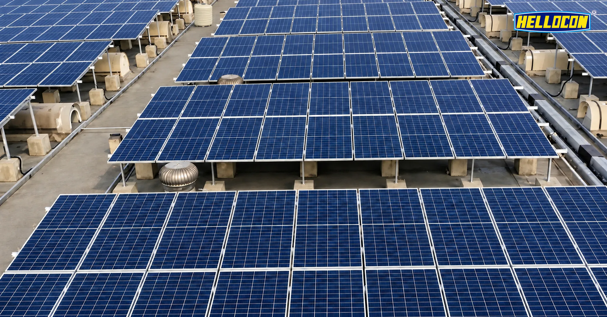 Panel tables on concrete pedestals above a factory roof at the HELLOCON 250 kWp industrial rooftop plant in Balasore