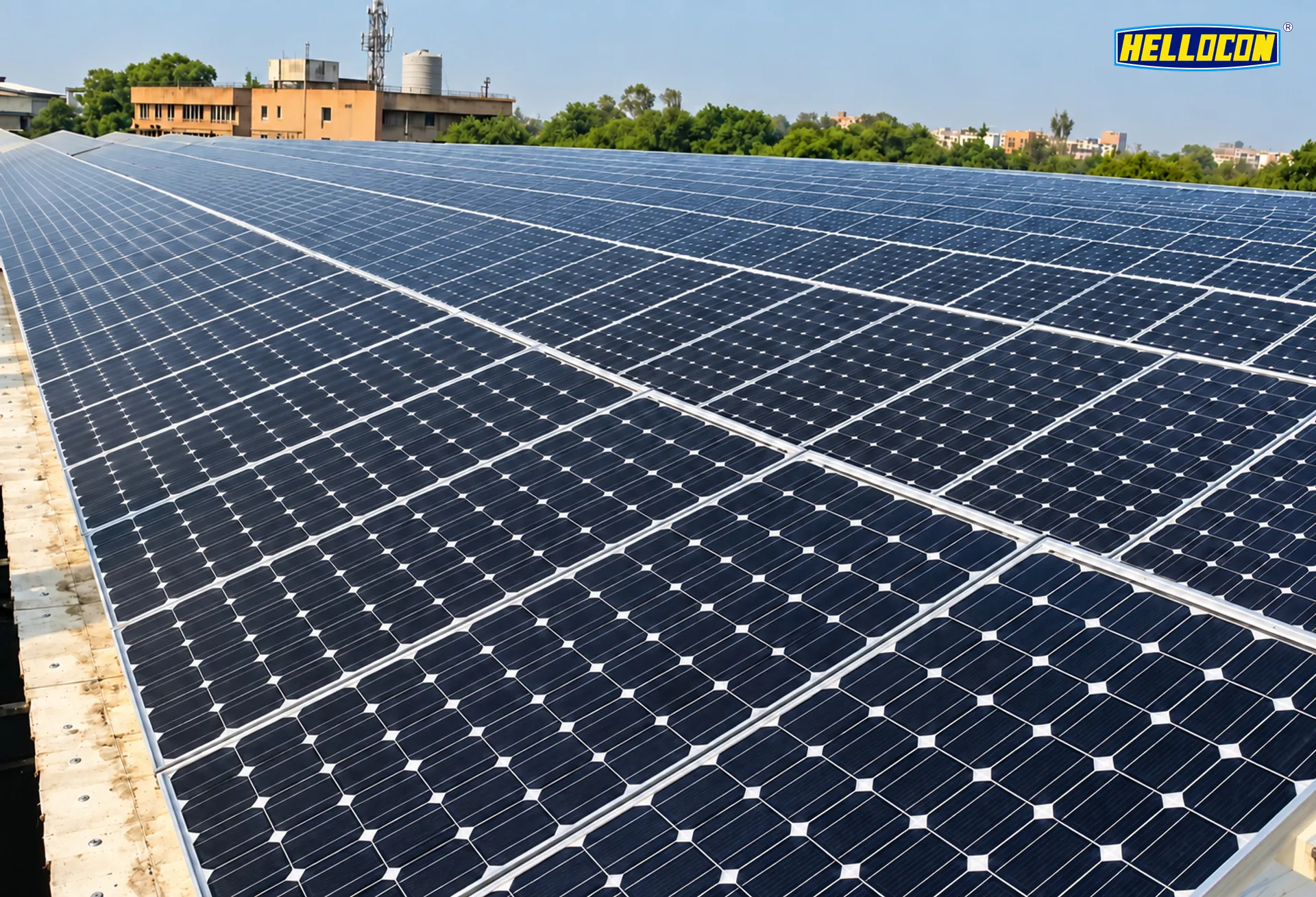 Monocrystalline panels across a flat roof with city buildings behind at the HELLOCON 200 kWp rooftop plant in Cuttack